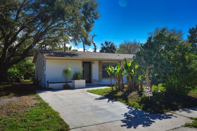 view of front of home featuring driveway and stucco siding