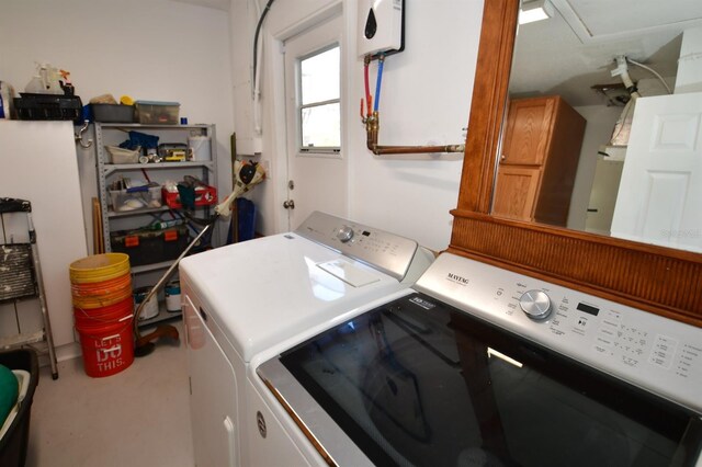 laundry room featuring laundry area, water heater, and separate washer and dryer