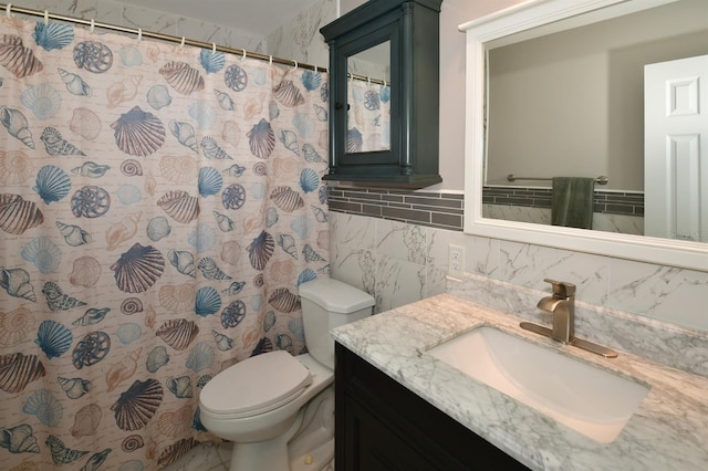 bathroom featuring toilet, curtained shower, tile walls, and vanity