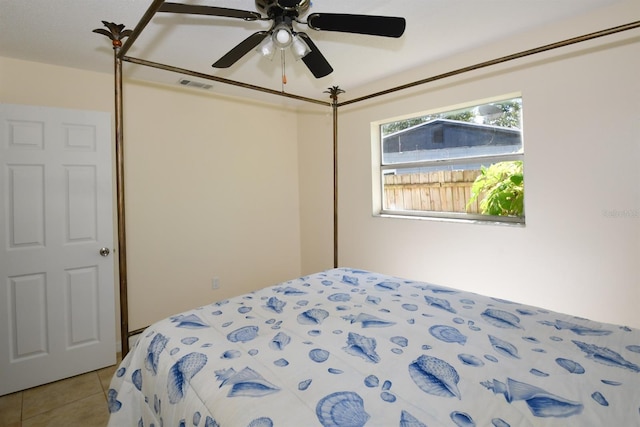 bedroom with light tile patterned floors, ceiling fan, and visible vents