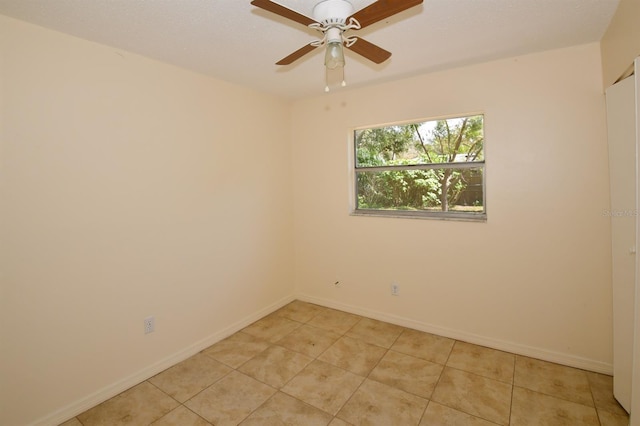 9567 85th St, Seminole, FL 33777 - unfurnished room featuring light tile patterned floors, baseboards, and ceiling fan