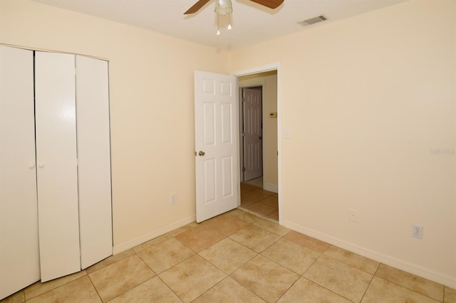 9567 85th St, Seminole, FL 33777 - unfurnished bedroom featuring light tile patterned flooring, a closet, ceiling fan, and baseboards