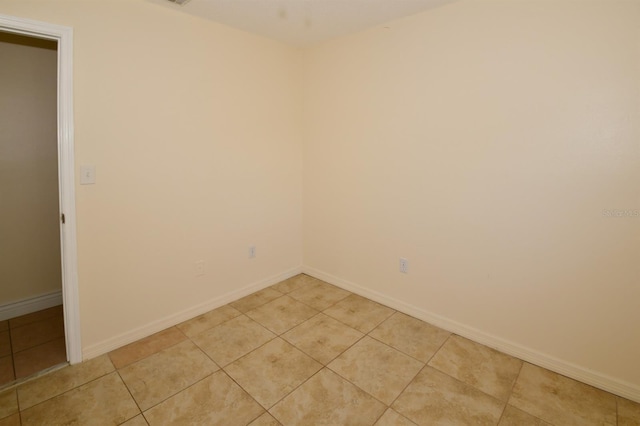9567 85th St, Seminole, FL 33777 - unfurnished room with light tile patterned flooring and baseboards