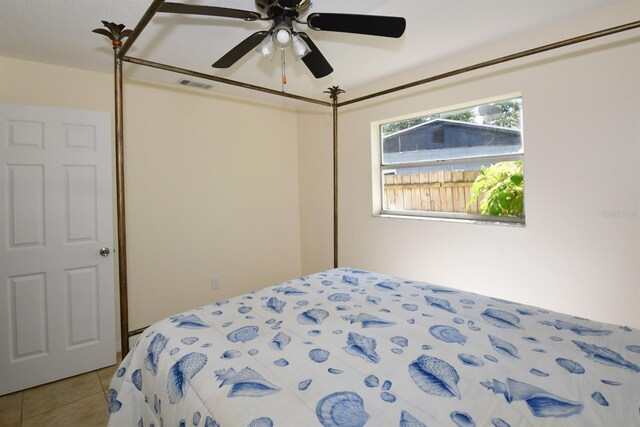 9567 85th St, Seminole, FL 33777 - bedroom with light tile patterned floors and ceiling fan