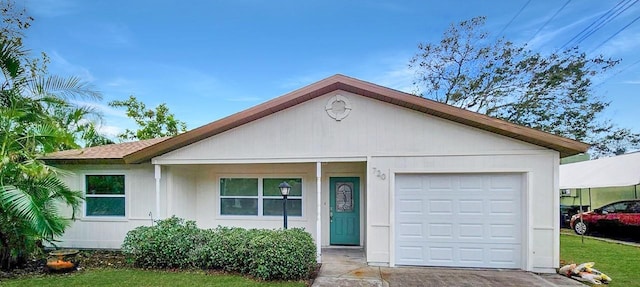 ranch-style house with a garage and a front lawn