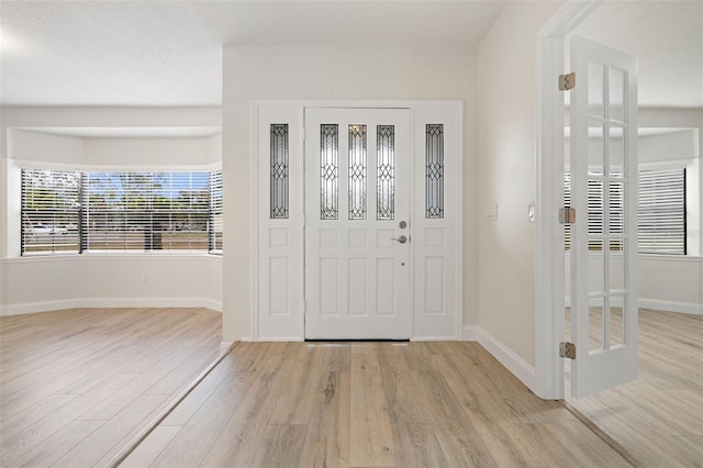 foyer entrance with light hardwood / wood-style floors