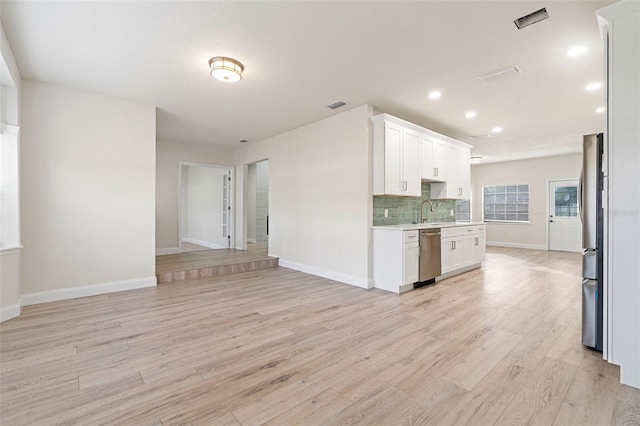 kitchen with white cabinets, stainless steel appliances, light hardwood / wood-style floors, and sink