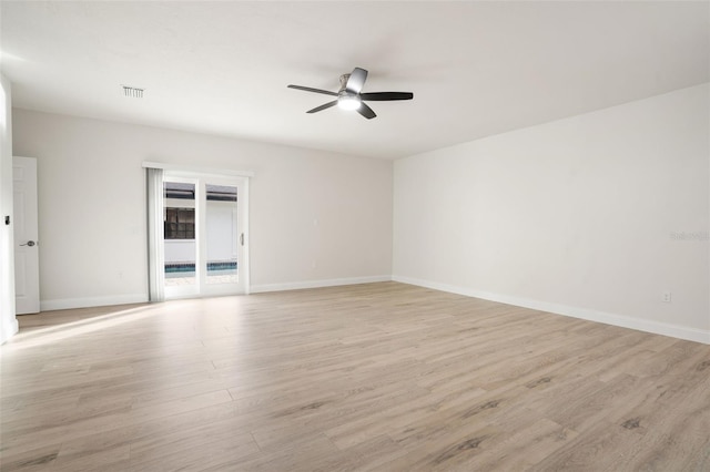 spare room with light wood-type flooring and ceiling fan