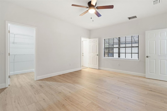 empty room with light hardwood / wood-style floors and ceiling fan