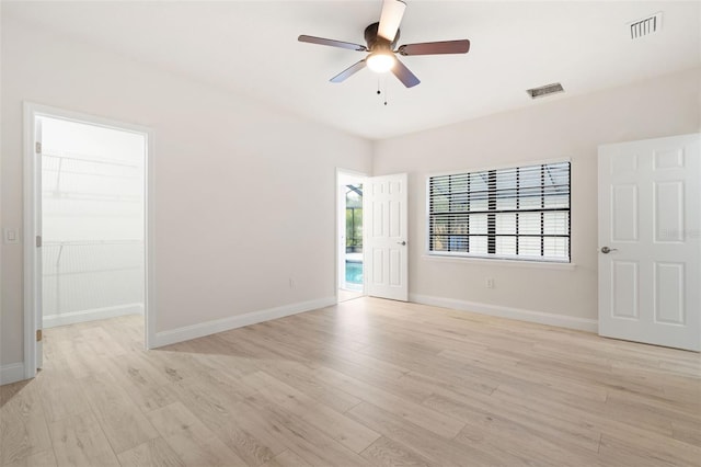 unfurnished room with ceiling fan and light wood-type flooring