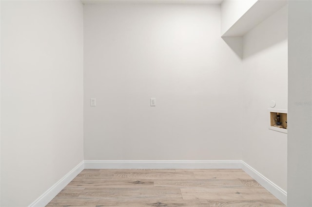 laundry room featuring hookup for a washing machine and light hardwood / wood-style flooring