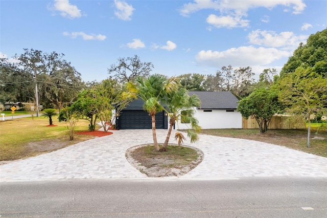 view of front of home featuring a garage and a front yard