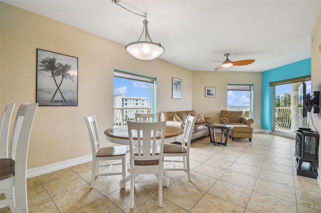 tiled dining area with ceiling fan