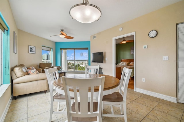 dining space featuring ceiling fan and light tile patterned flooring