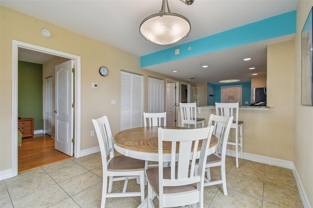 dining space featuring light tile patterned floors