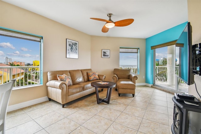 living room with ceiling fan, plenty of natural light, and light tile patterned flooring