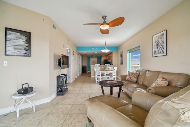 living room featuring ceiling fan and light tile patterned flooring