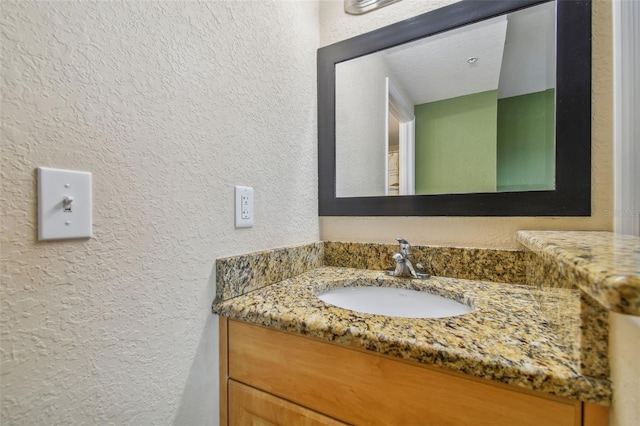 bathroom with vanity and a textured ceiling