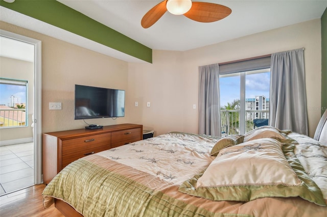 bedroom featuring ceiling fan, access to outside, and light hardwood / wood-style flooring