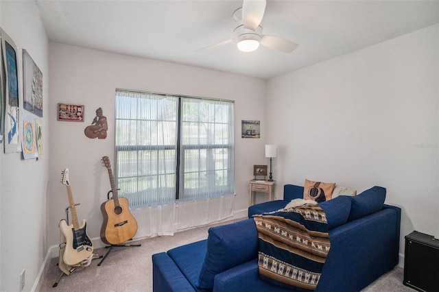 living area with carpet and ceiling fan