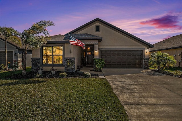 view of front of house featuring a yard and a garage