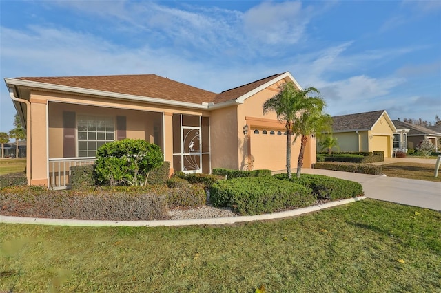 ranch-style home featuring a garage and a front lawn