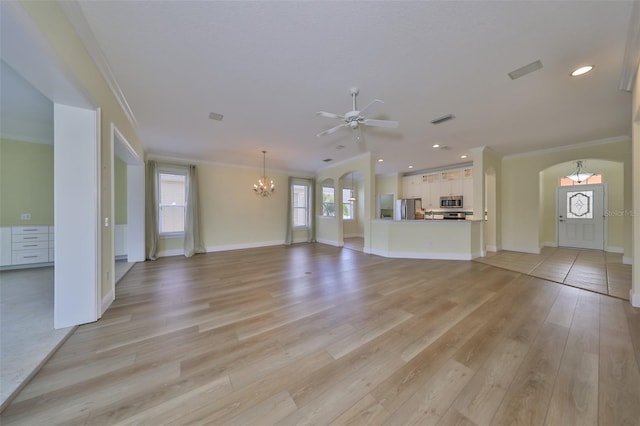 unfurnished living room featuring crown molding, ceiling fan with notable chandelier, and light wood-type flooring