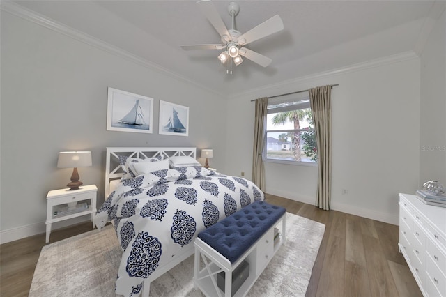 bedroom featuring ceiling fan, crown molding, and light hardwood / wood-style flooring