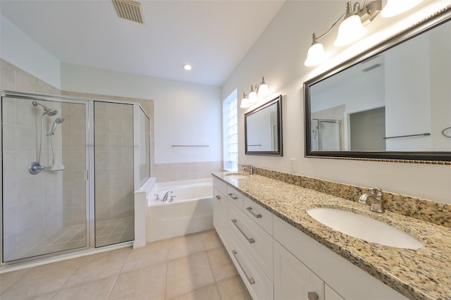 bathroom featuring tile patterned flooring, shower with separate bathtub, and vanity