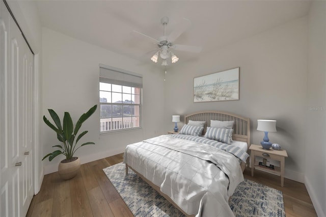 bedroom with wood-type flooring, a closet, and ceiling fan