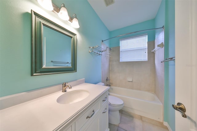 full bathroom featuring tile patterned floors, vanity, toilet, and tiled shower / bath