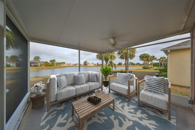 sunroom featuring ceiling fan and a water view