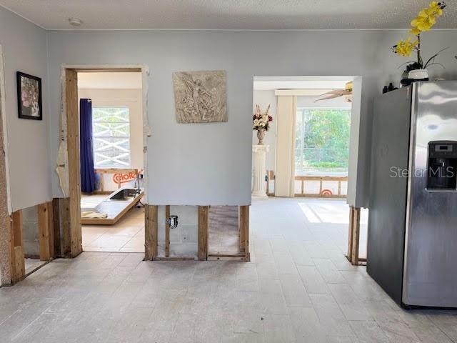 hallway with a textured ceiling