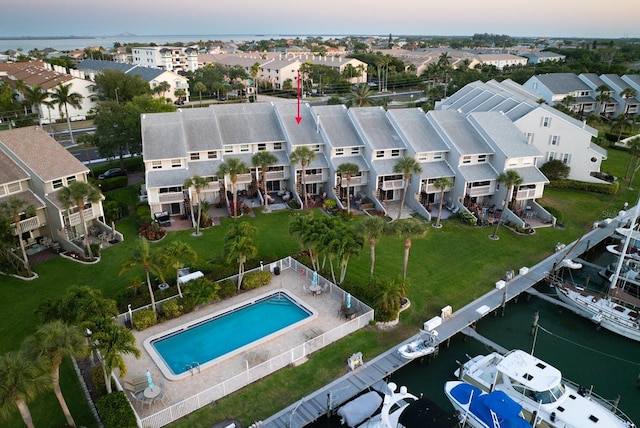 aerial view at dusk featuring a water view