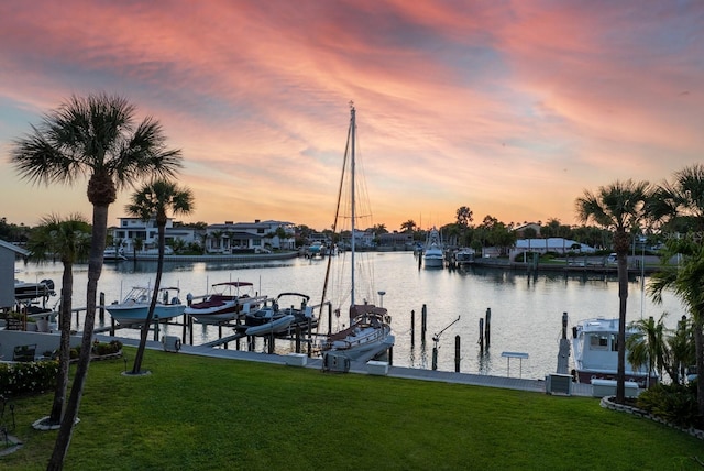 dock area with a water view, cooling unit, and a lawn