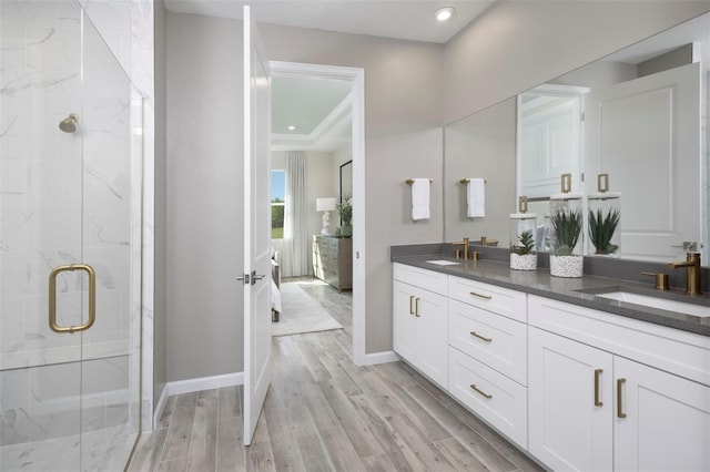 bathroom featuring hardwood / wood-style floors, vanity, and an enclosed shower