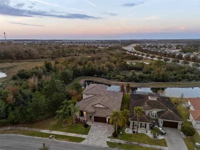 aerial view at dusk with a water view