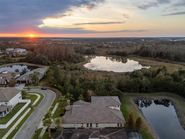 aerial view at dusk with a water view