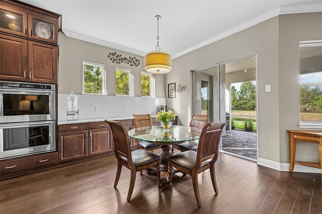 dining area featuring dark hardwood / wood-style floors and crown molding