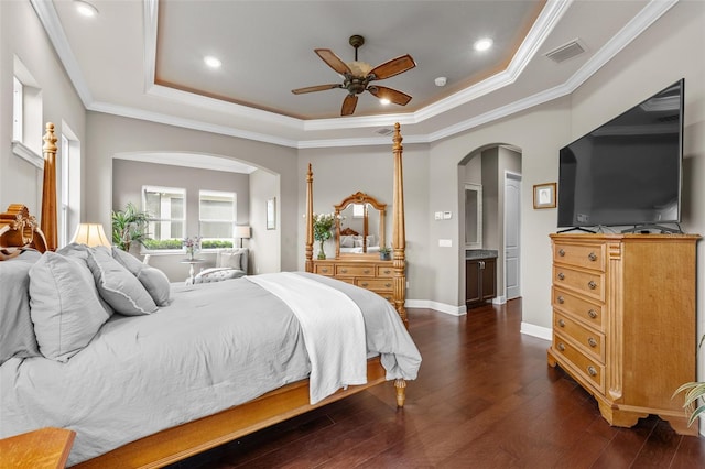 bedroom featuring a tray ceiling, ceiling fan, crown molding, and dark wood-type flooring