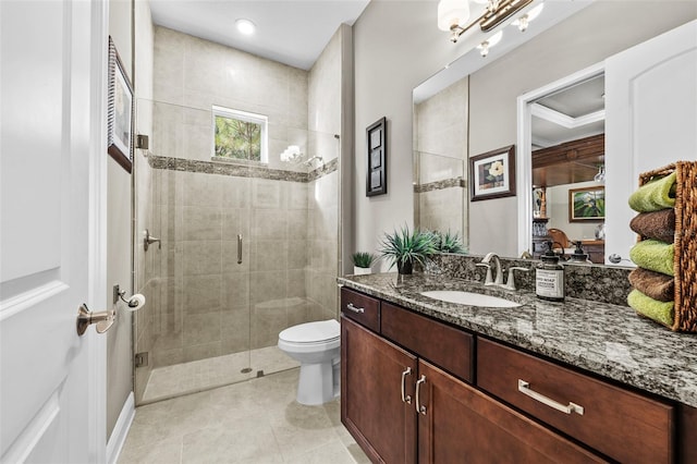 bathroom with tile patterned flooring, vanity, toilet, and a shower with door