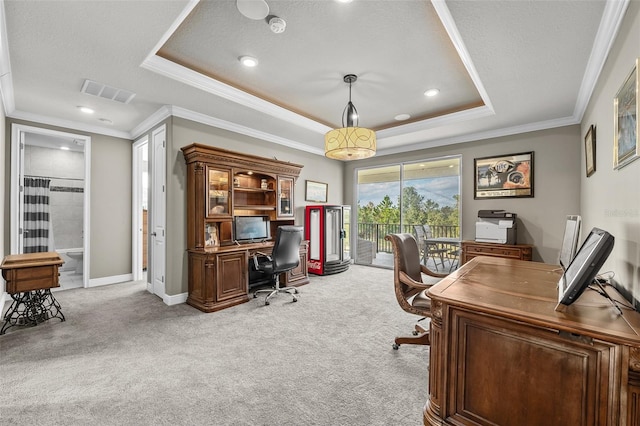 carpeted home office featuring a textured ceiling, a tray ceiling, and ornamental molding