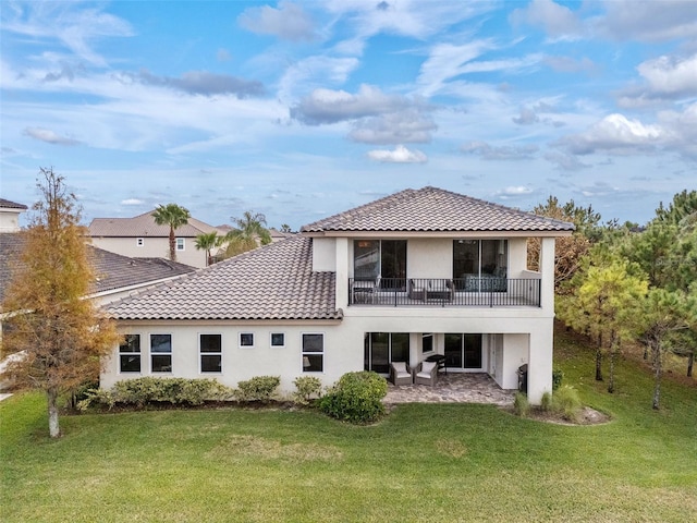 rear view of property featuring a yard and a patio area