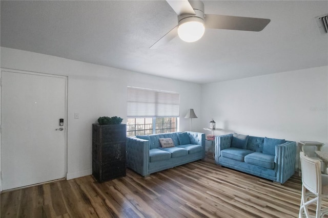 unfurnished living room featuring ceiling fan and wood-type flooring