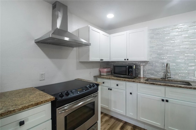 kitchen with white cabinets, sink, stainless steel range with electric cooktop, and wall chimney range hood