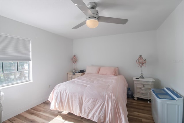 bedroom with ceiling fan and light hardwood / wood-style floors