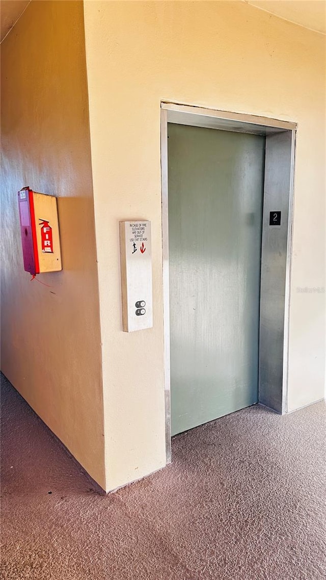 room details with carpet floors and elevator