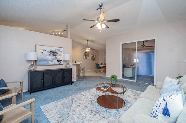 carpeted living room featuring a textured ceiling and vaulted ceiling