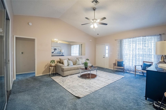 carpeted living room with a textured ceiling, a wealth of natural light, lofted ceiling, and ceiling fan