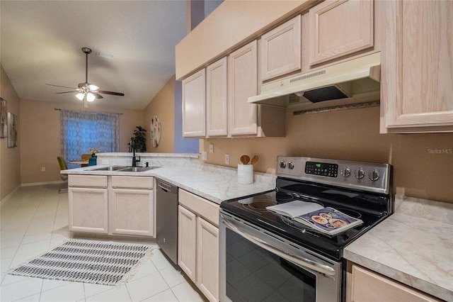 kitchen with light tile patterned flooring, stainless steel appliances, and light brown cabinetry